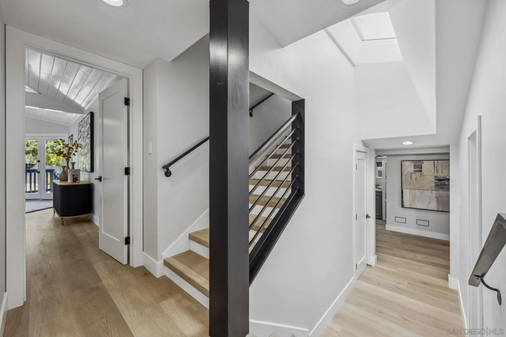 2026 Estero Street Oceanside, CA 92054 - Photo 40 of 72 a view of a hallway with wooden floor and stairs