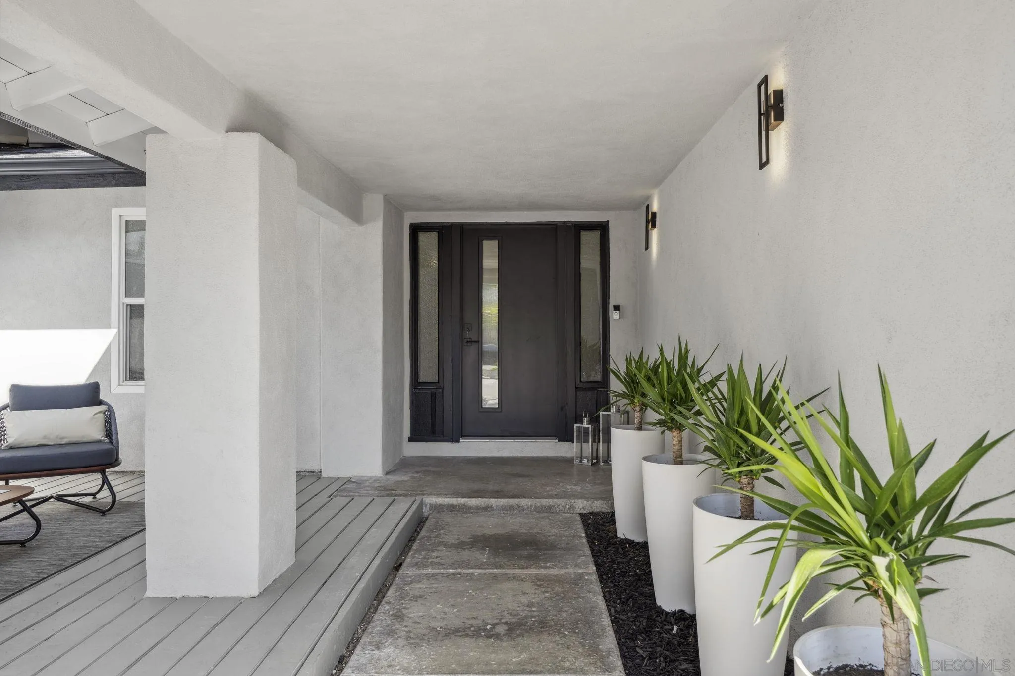 2026 Estero Street Oceanside, CA 92054 - Photo 65 of 72 a view of a hallway to a house with wooden floor and a potted plant