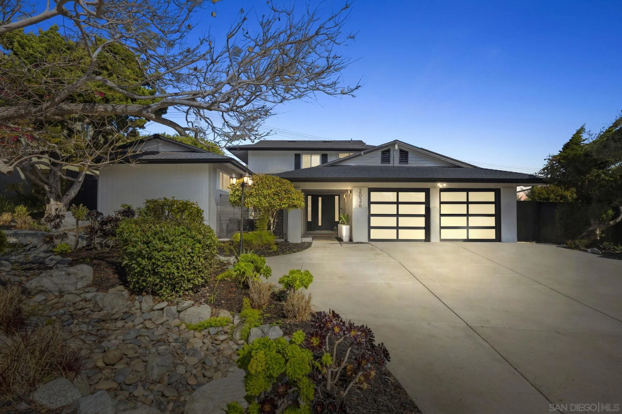 2026 Estero Street Oceanside, CA 92054 - Photo 71 of 72 a front view of a house with a yard and garage