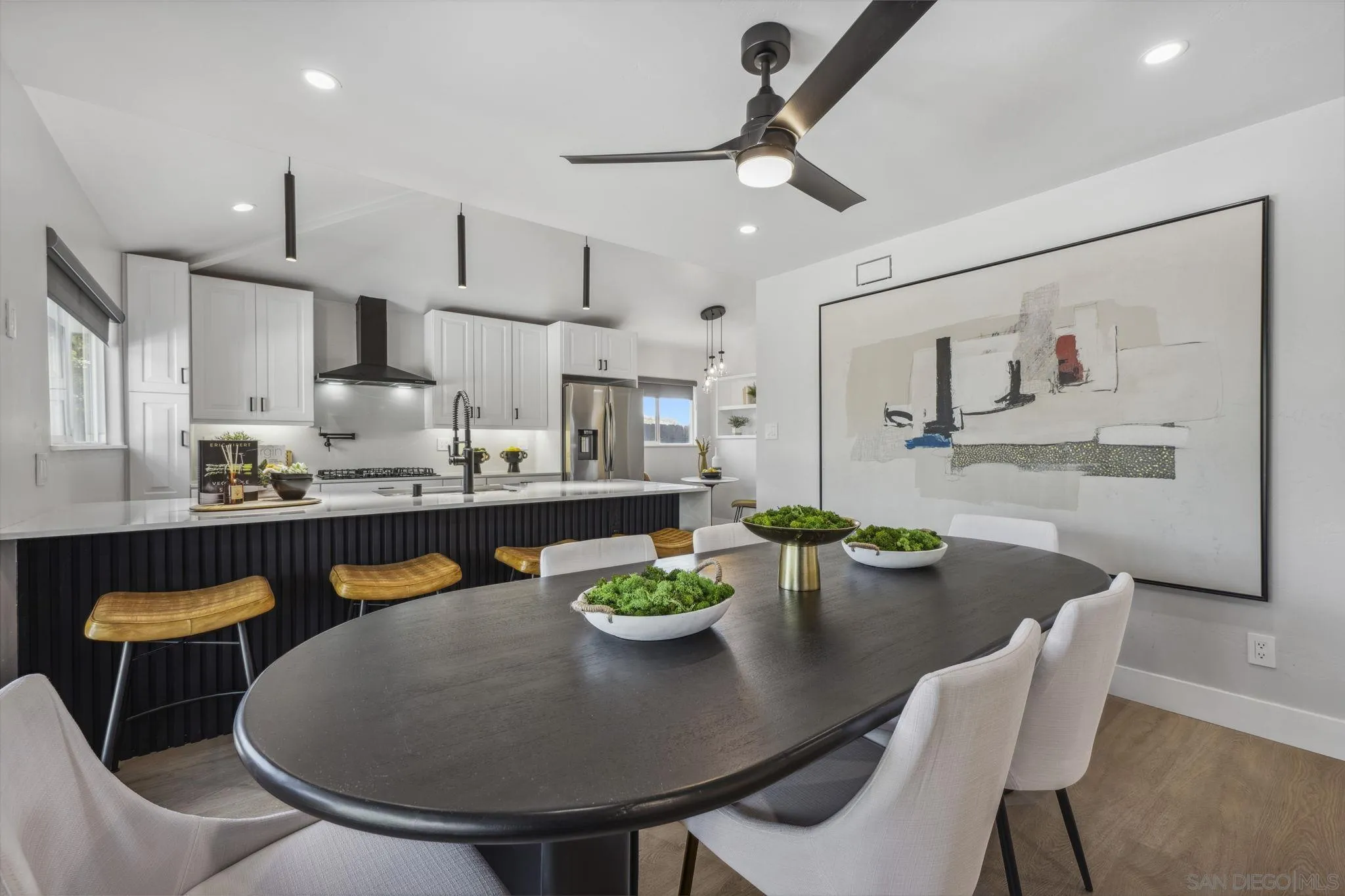 2026 Estero Street Oceanside, CA 92054 - Photo 10 of 72 a view of a dining room with furniture a kitchen and chandelier