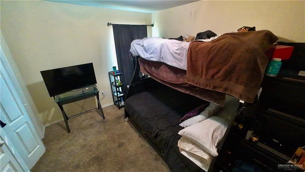 412 Rio Nueces San Juan, TX 78589 - Photo 13 of 19 a living room with a bed furniture and a flat screen tv