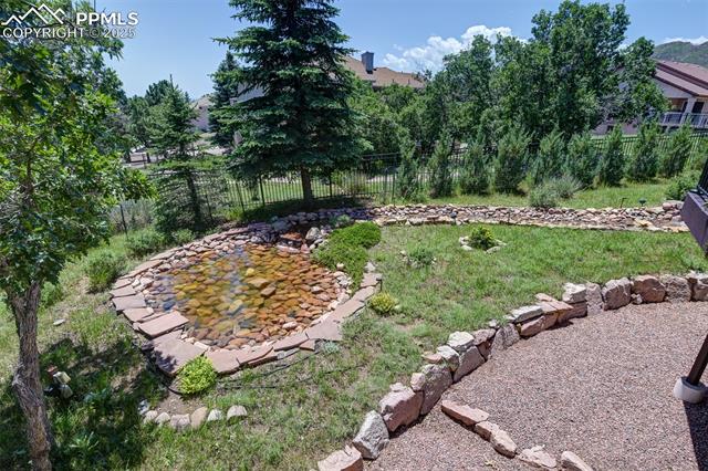 6240 Wilson Road Colorado Springs, CO 80919 - Photo 37 of 42 Relax in the shade and enjoy this view from covered patio area. Ornamental pond is easy to maintain.
