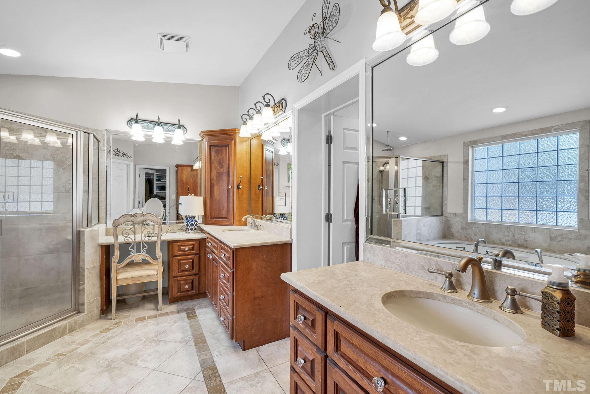 7101 Denlee Road Raleigh, NC 27603 - Photo 17 of 32 a large bathroom with a sink a large mirror and a shower