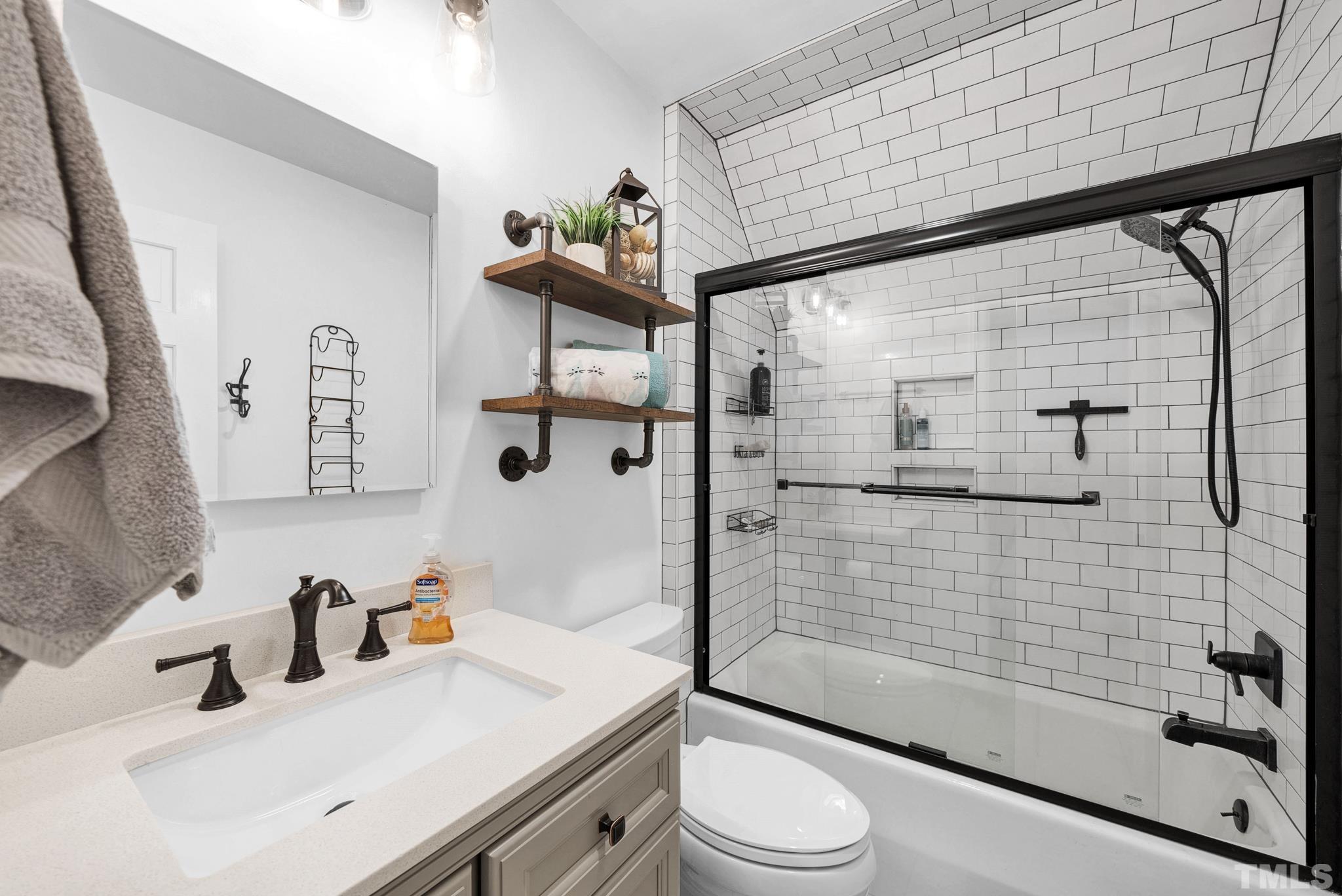 7101 Denlee Road Raleigh, NC 27603 - Photo 19 of 32 a bathroom with a sink toilet and shower