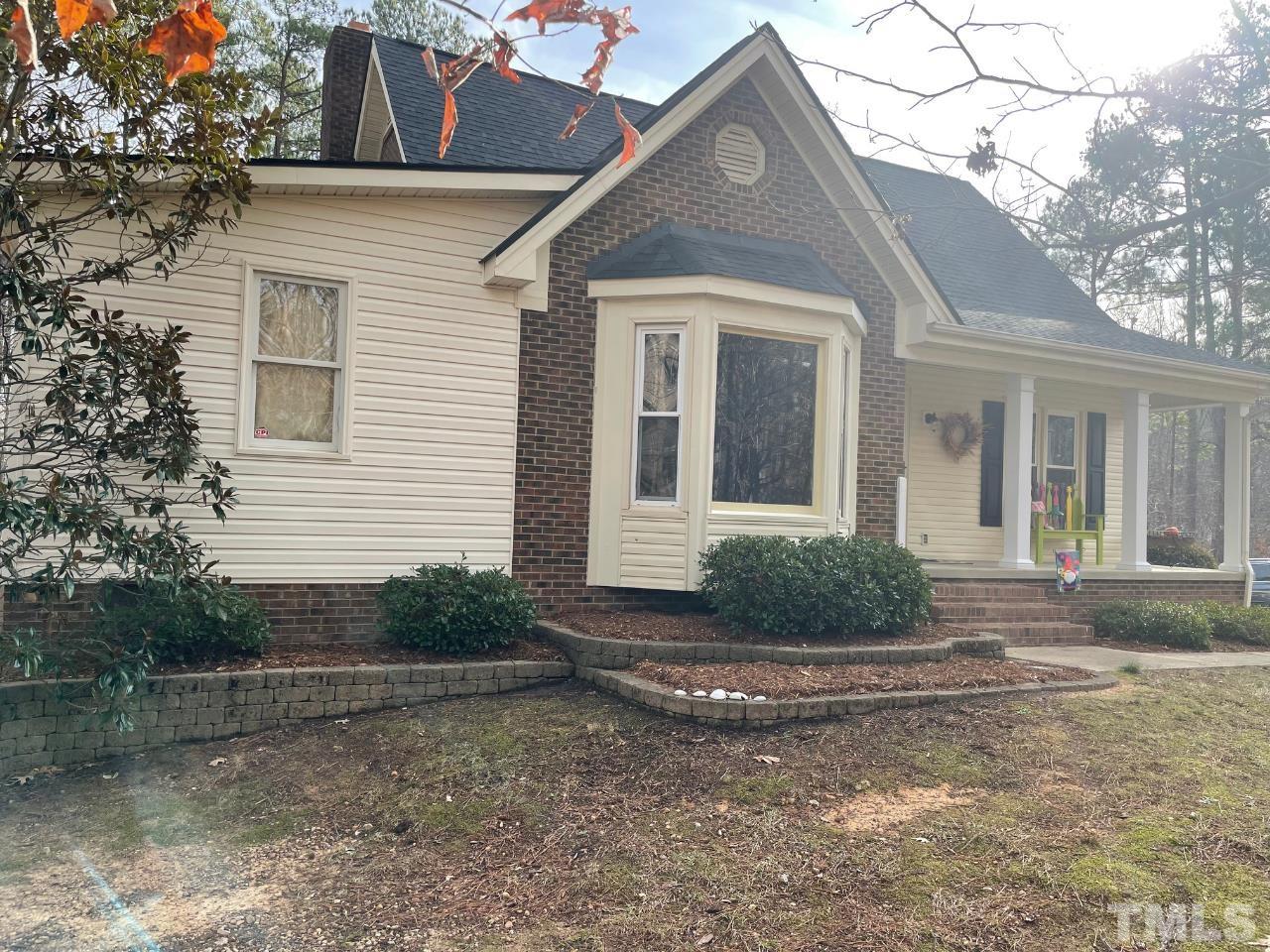 7101 Denlee Road Raleigh, NC 27603 - Photo 2 of 32 a front view of a house with garden