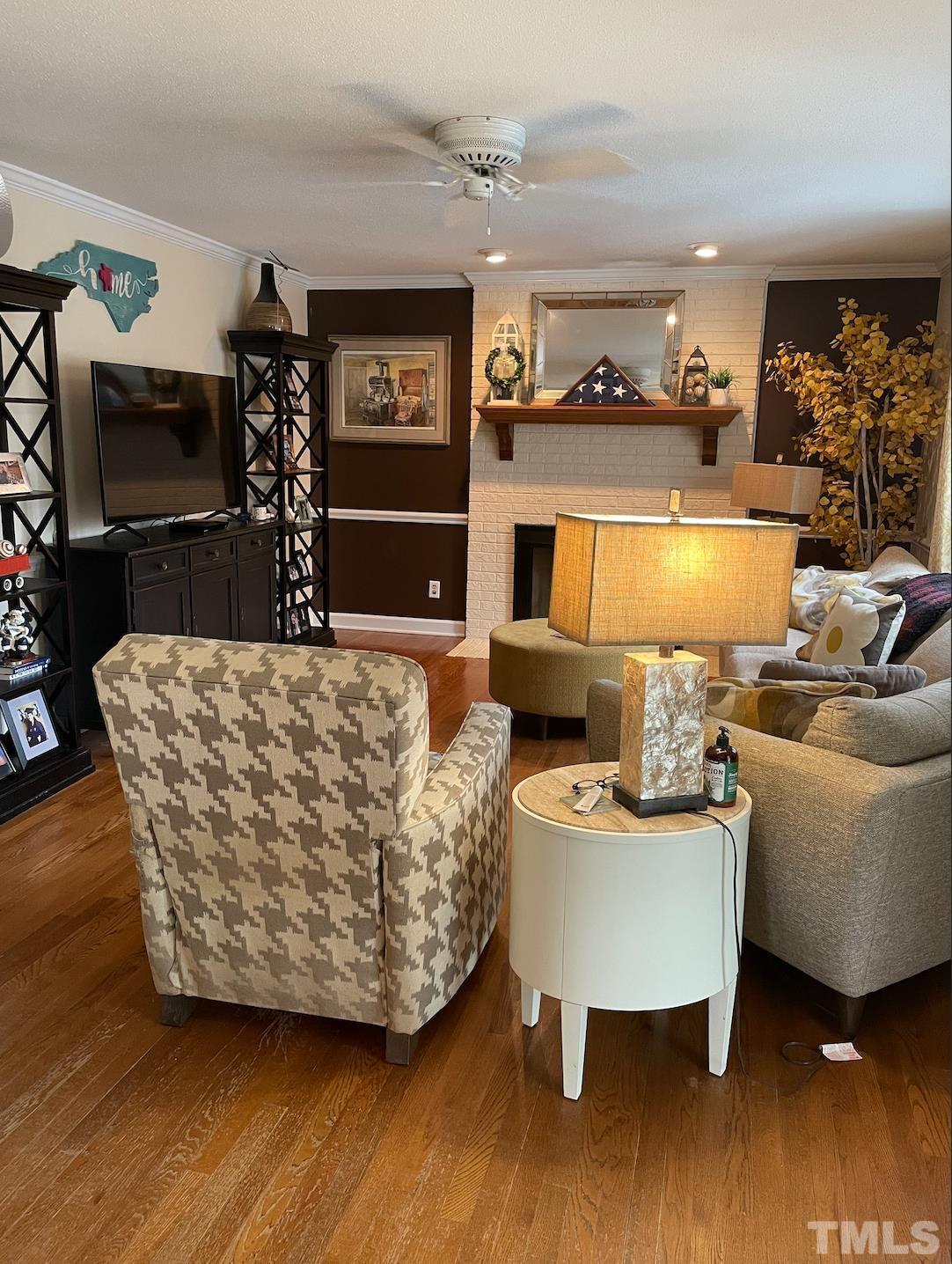 7101 Denlee Road Raleigh, NC 27603 - Photo 6 of 32 a living room with furniture and a flat screen tv