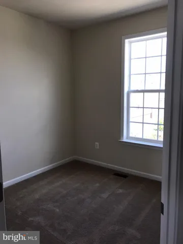 a bathroom with a granite countertop toilet sink and mirror