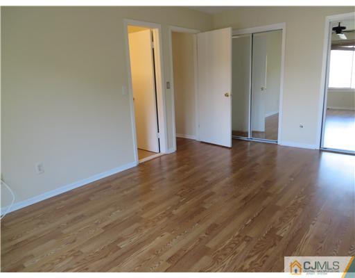 36 Gable Court Old Bridge, NJ 07747 - Photo 11 of 22 a view of an empty room with wooden floor and closet