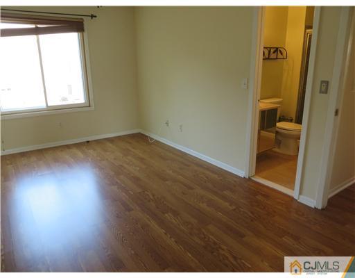36 Gable Court Old Bridge, NJ 07747 - Photo 12 of 22 an empty room with wooden floor and windows