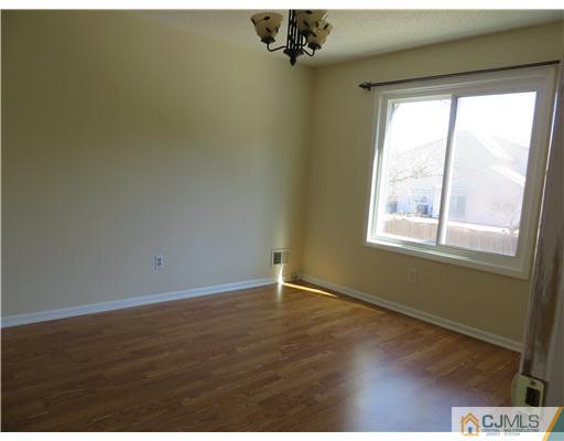 36 Gable Court Old Bridge, NJ 07747 - Photo 17 of 22 an empty room with wooden floor and windows