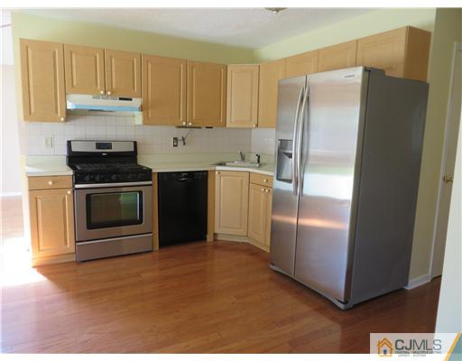 36 Gable Court Old Bridge, NJ 07747 - Photo 7 of 22 a kitchen with stainless steel appliances granite countertop a refrigerator a stove and a sink