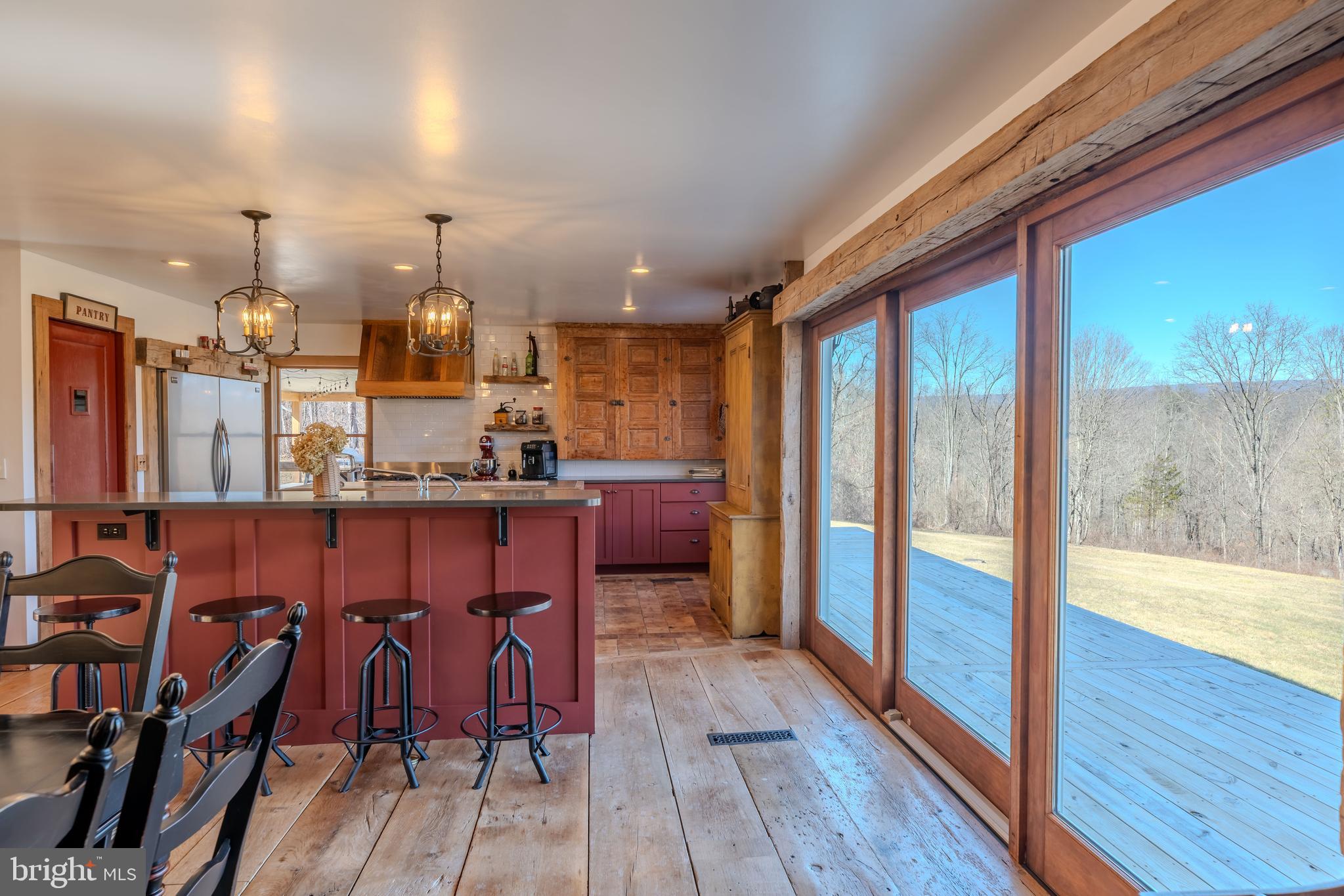 651 Robinson Road Newport, PA 17074 - Photo 13 of 87 a kitchen with stainless steel appliances a dining table chairs stove and wooden floor