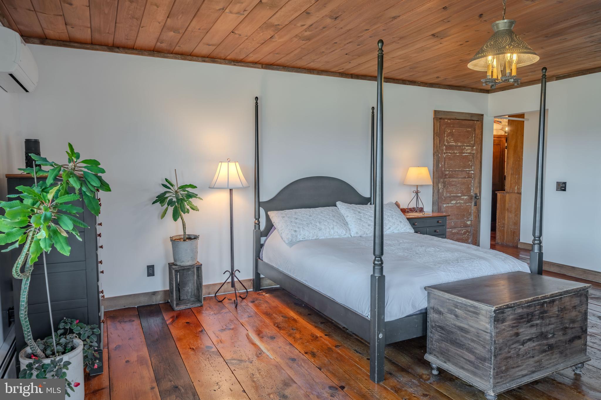 651 Robinson Road Newport, PA 17074 - Photo 36 of 87 a bedroom with a bed and a potted plant