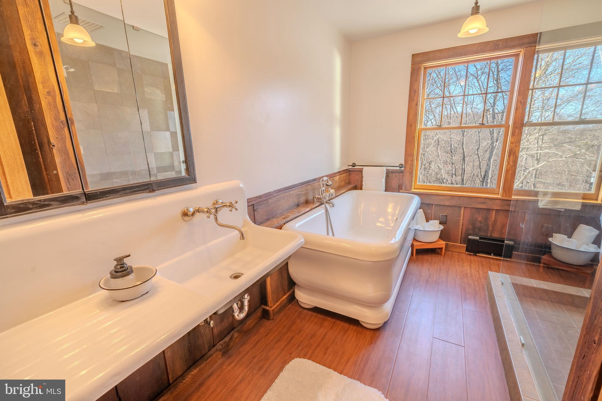 651 Robinson Road Newport, PA 17074 - Photo 44 of 87 a bathroom with a tub a sink and a large mirror