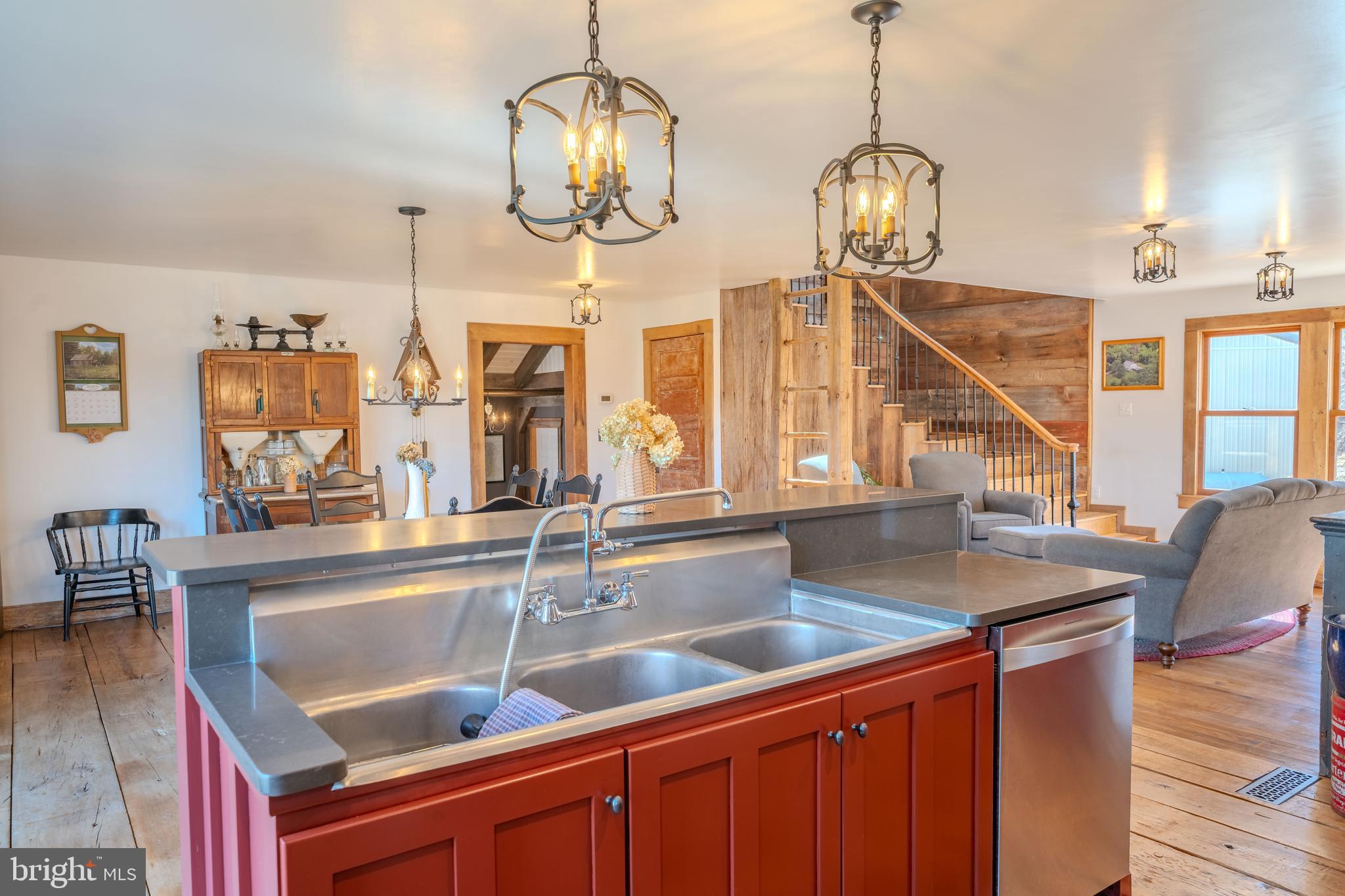 651 Robinson Road Newport, PA 17074 - Photo 9 of 87 a view of a kitchen island stainless steel appliances sink and wooden floor