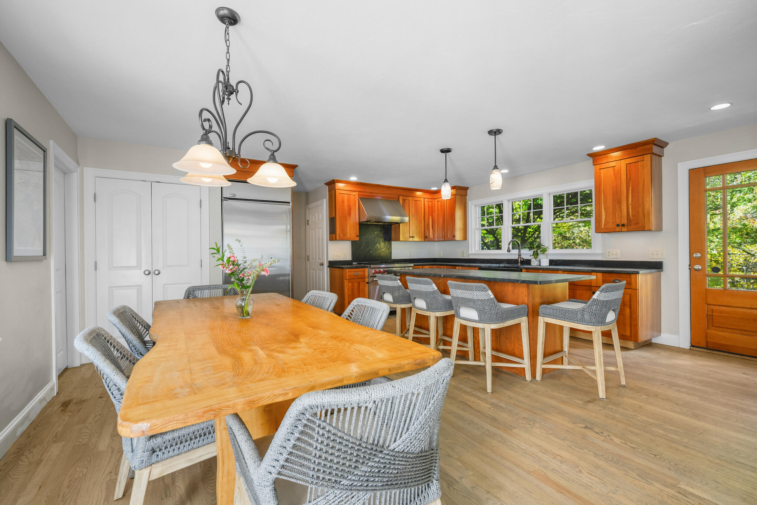 250 The Plains Road West Barnstable, MA 02668 - Photo 11 of 44 a dining room with furniture a chandelier and wooden floor