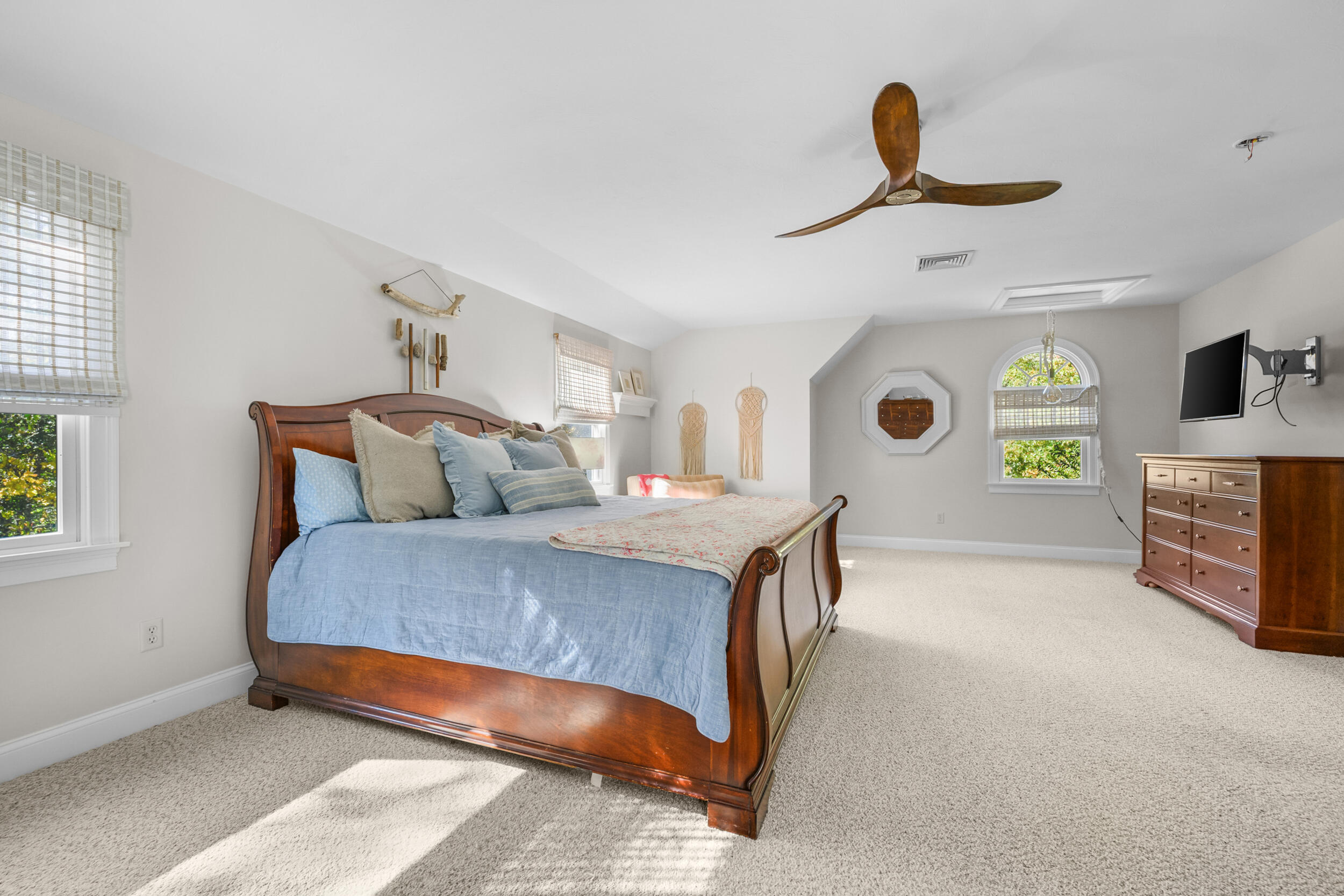 250 The Plains Road West Barnstable, MA 02668 - Photo 15 of 44 a bedroom with a bed and a chandelier