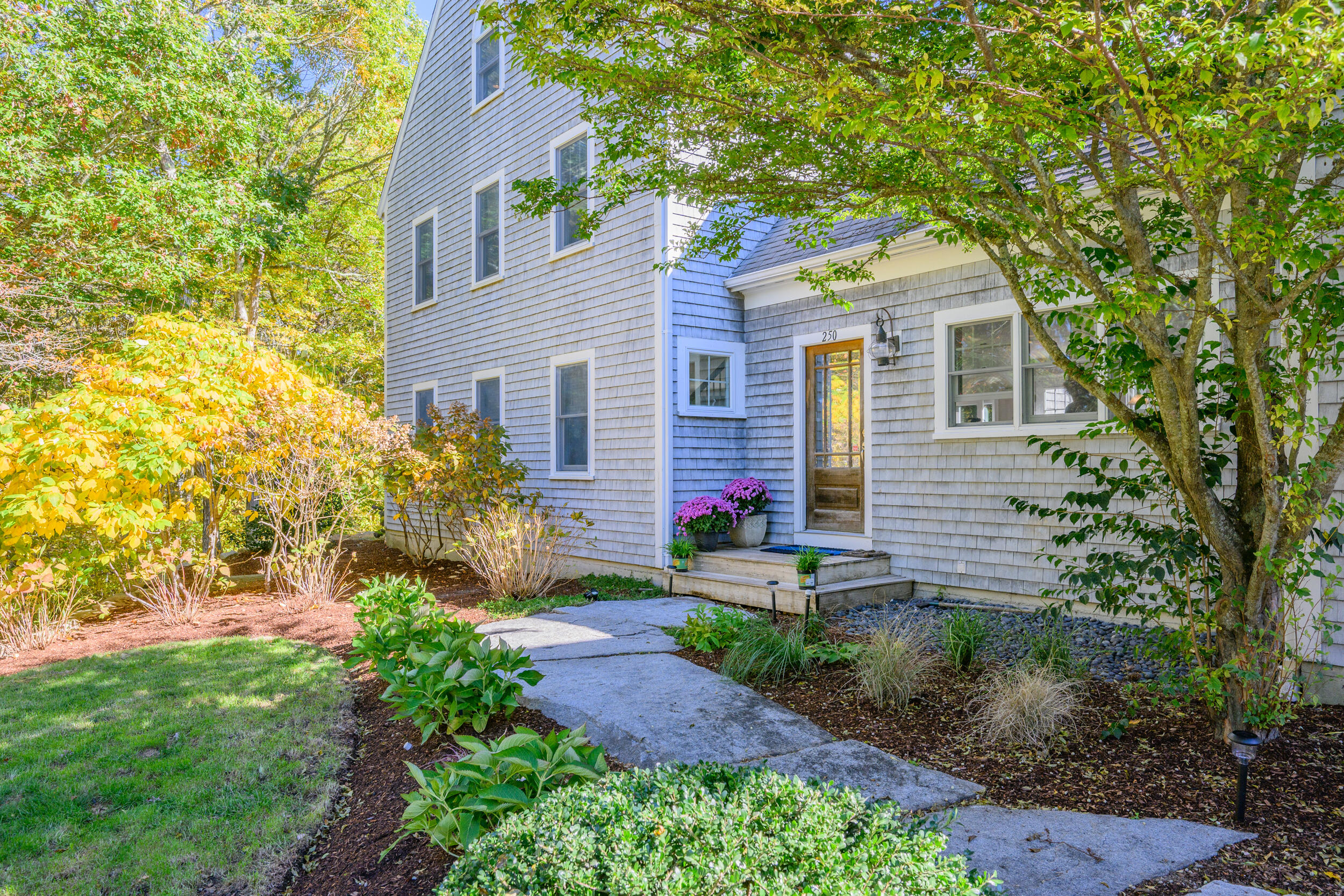 250 The Plains Road West Barnstable, MA 02668 - Photo 2 of 44 a front view of house with yard and trees