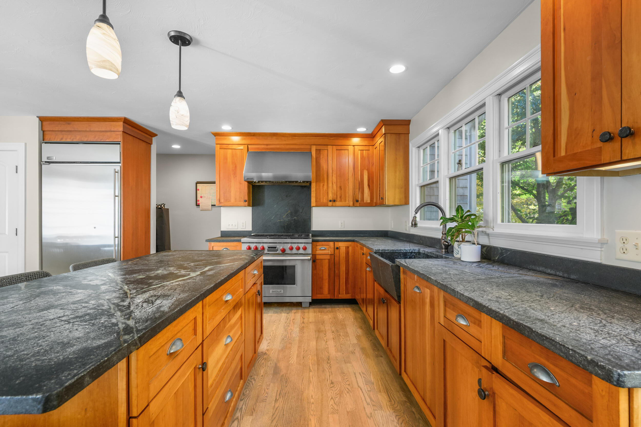 250 The Plains Road West Barnstable, MA 02668 - Photo 7 of 44 a kitchen with stainless steel appliances granite countertop a sink a stove and a wooden floors