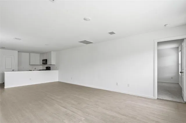a view of a kitchen with a sink and a refrigerator