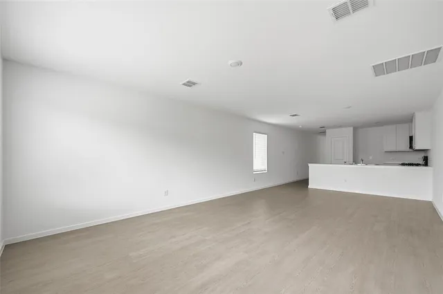 a view of empty room with kitchen appliances