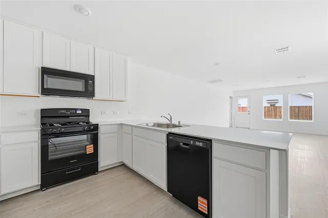 a kitchen with a sink and stainless steel appliances