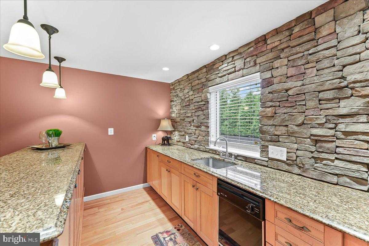 780 Tannery Drive Wayne, PA 19087 - Photo 21 of 59 a kitchen with granite countertop a sink and a wooden floor