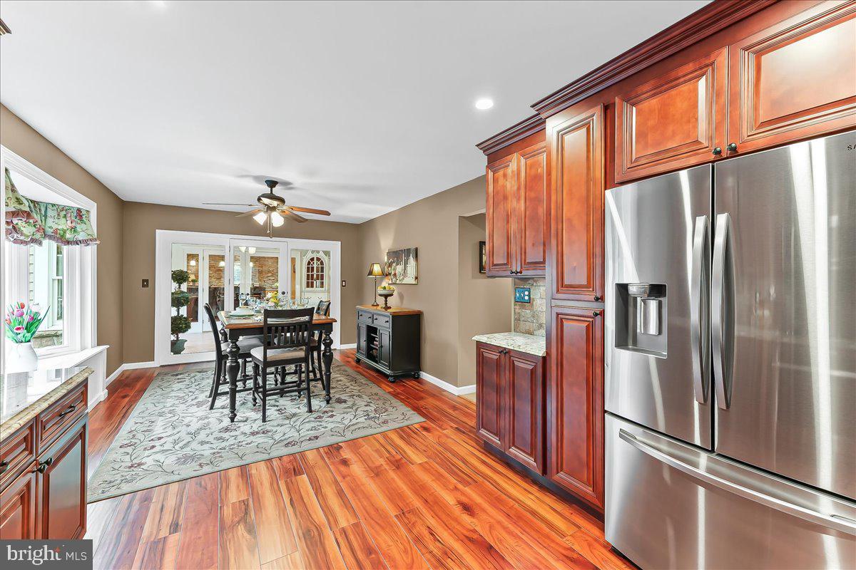 780 Tannery Drive Wayne, PA 19087 - Photo 26 of 59 a kitchen with stainless steel appliances granite countertop a refrigerator stove microwave and wooden floor