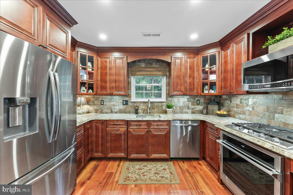 780 Tannery Drive Wayne, PA 19087 - Photo 29 of 59 a kitchen with stainless steel appliances granite countertop a sink stove and refrigerator
