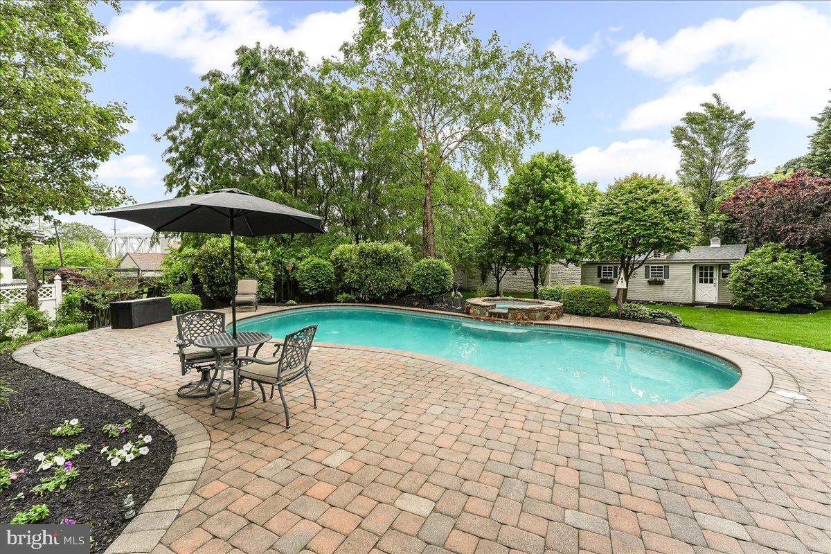 780 Tannery Drive Wayne, PA 19087 - Photo 55 of 59 a view of a swimming pool with chair and table in the patio