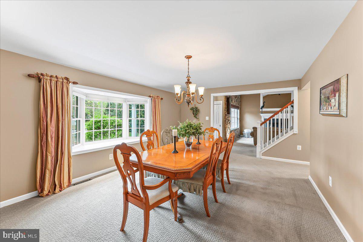 780 Tannery Drive Wayne, PA 19087 - Photo 9 of 59 a dining room with furniture a chandelier and wooden floor