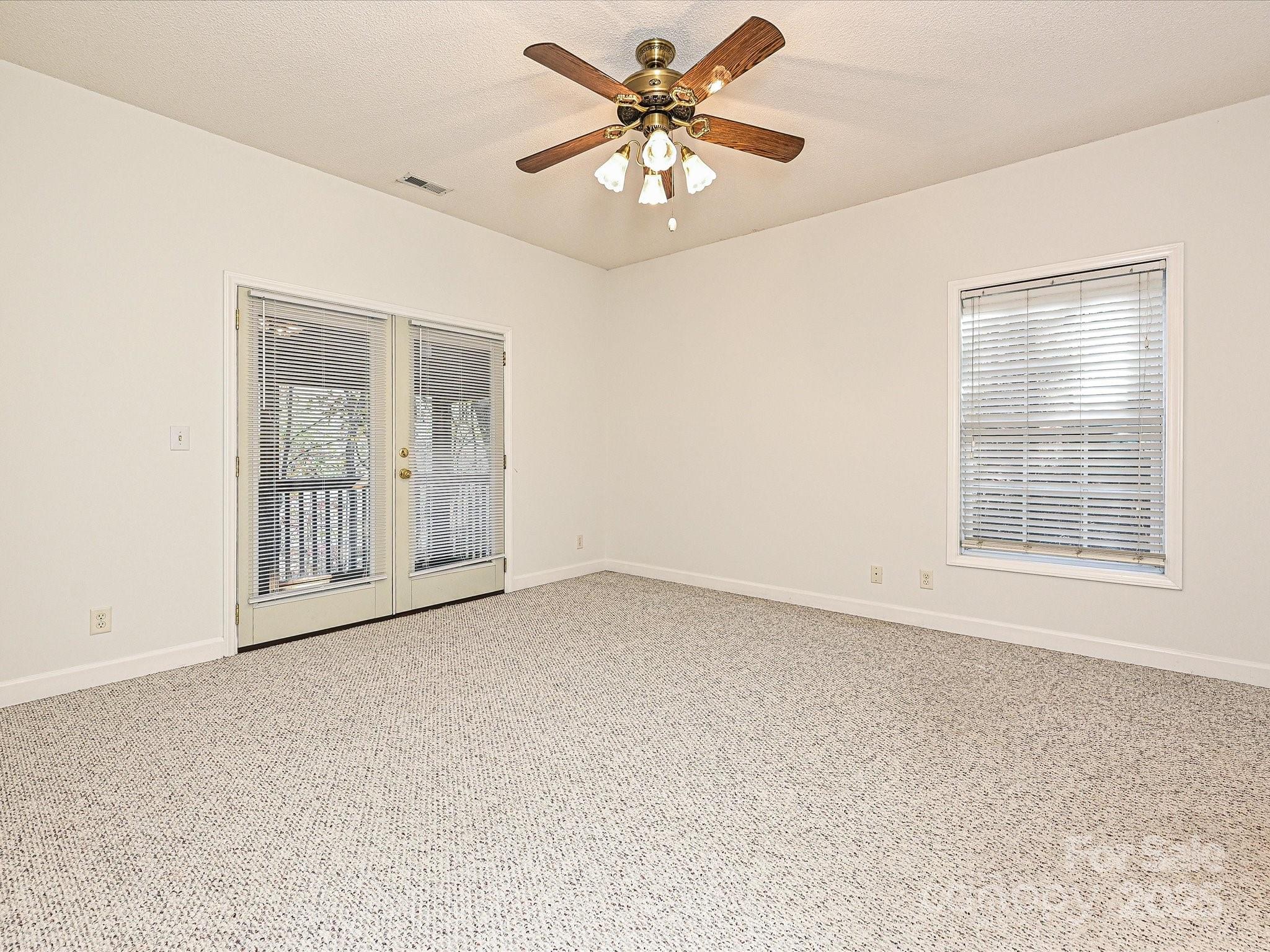 25040 Timberlake Drive Tega Cay, SC 29708 - Photo 22 of 40 an empty room with windows and fan