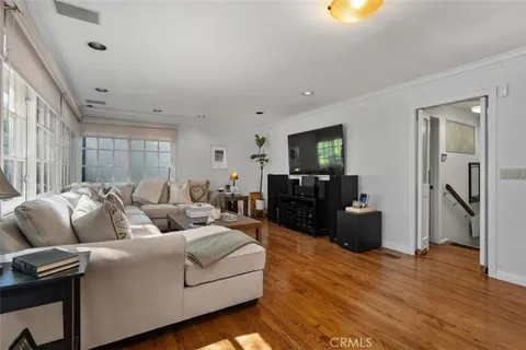 a kitchen with stainless steel appliances granite countertop a stove a sink a microwave a dining table and chairs