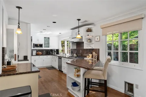 a kitchen with stainless steel appliances a refrigerator sink and microwave