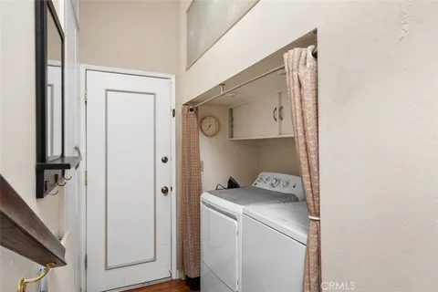 a view of a patio with table and chairs under an umbrella