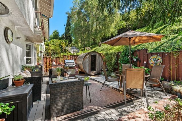a view of a patio with table and chairs potted plants and tree