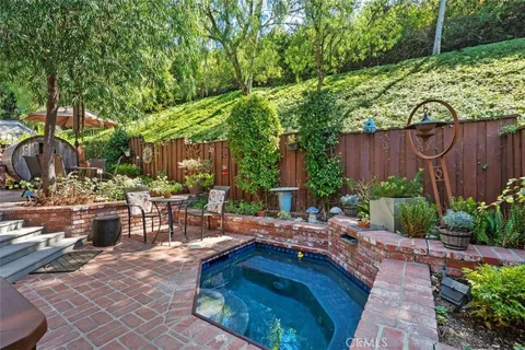 a living room with furniture a window and wooden floor