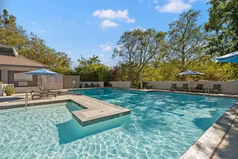 a view of a swimming pool and lounge chairs