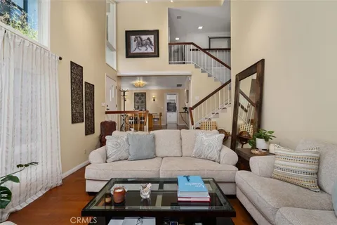 a living room with furniture a fireplace and a chandelier