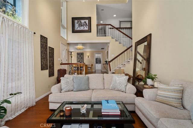 a living room with furniture a fireplace and a chandelier
