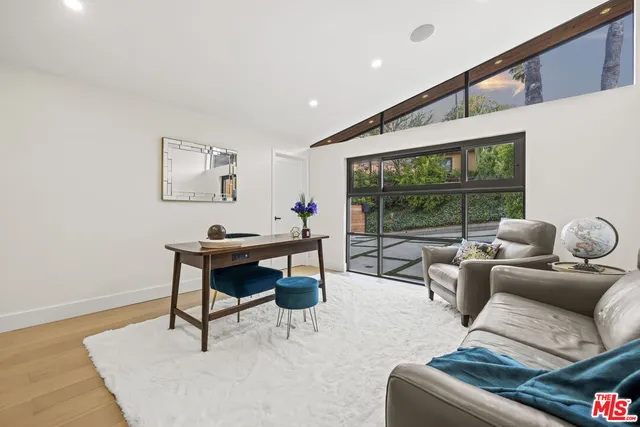 a bathroom with a granite countertop sink a mirror and shower