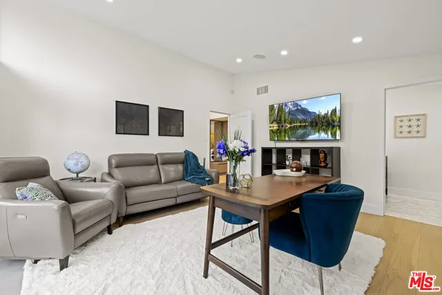 a spacious bedroom with a large bed and a large window