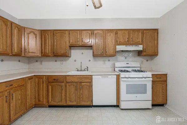 a kitchen with a stove sink and cabinets
