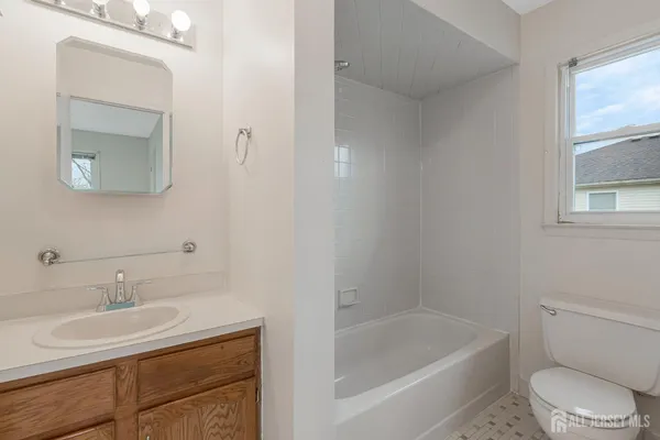 a bathroom with a sink toilet a vanity and bathtub