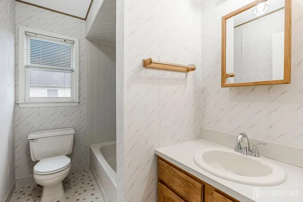 a bathroom with a sink toilet and mirror