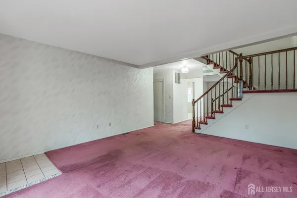 a view of an empty room with stairs