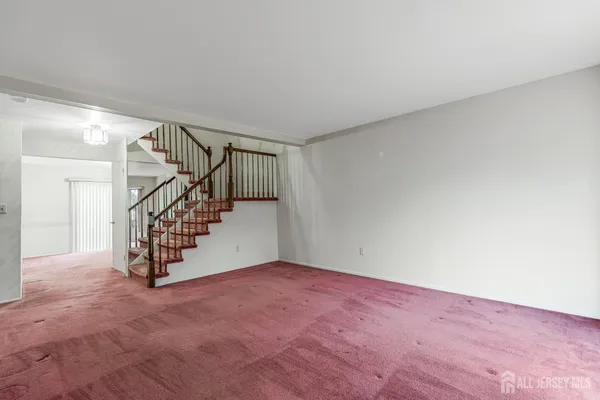 a view of an empty room with stairs