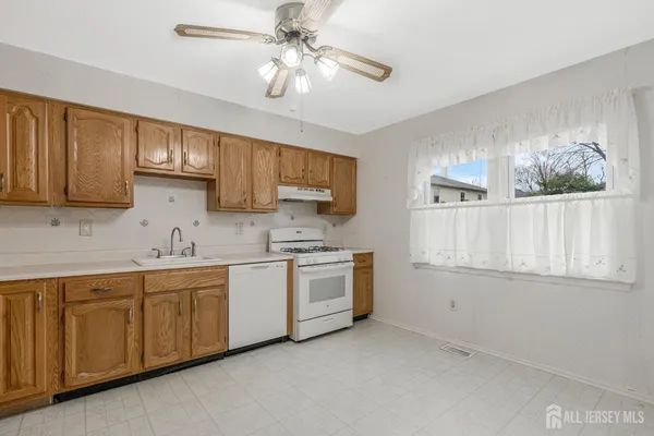 a kitchen with stainless steel appliances granite countertop a stove sink and cabinets