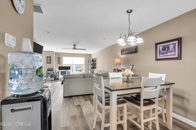 a view of a dining room with furniture and chandelier