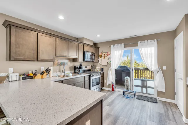 a kitchen with refrigerator and window